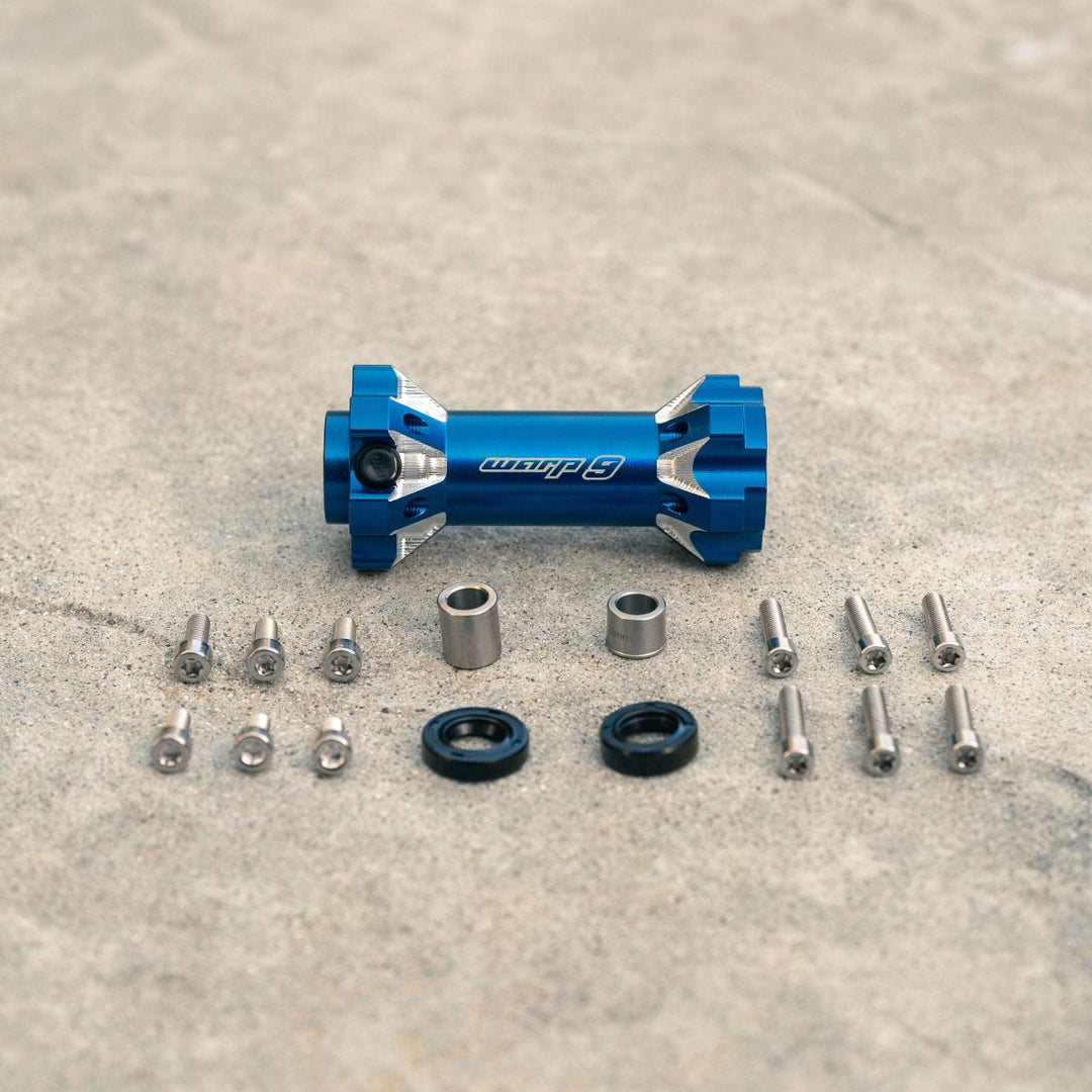 Warp 9 jackshaft kit in blue with components, including bolts, seals, and distance tubes