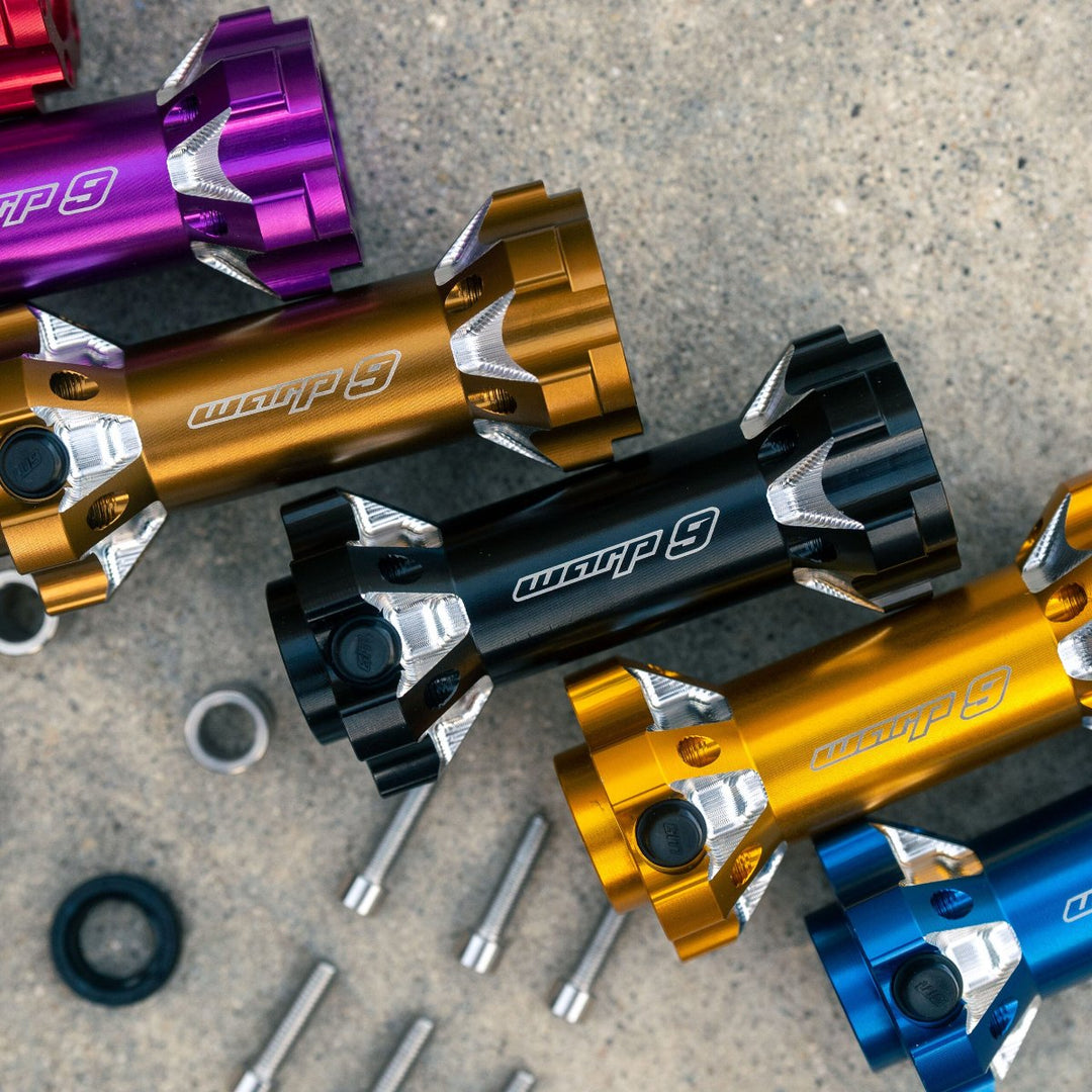 Color options for Warp 9 jackshaft, featuring anodized black, gold, purple, and blue finishes