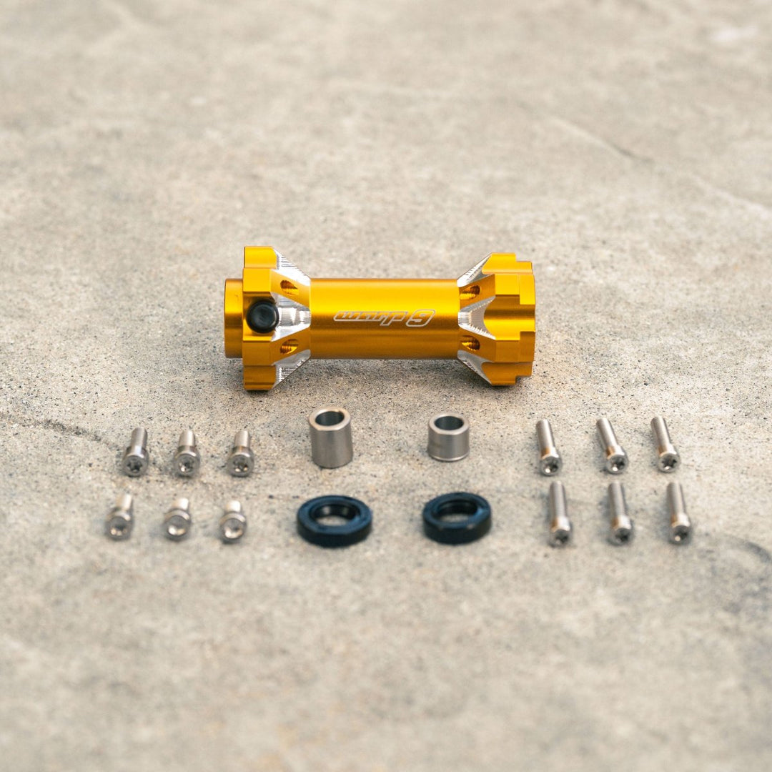 Warp 9 jackshaft kit in gold color with components, including bolts, seals, and distance tubes