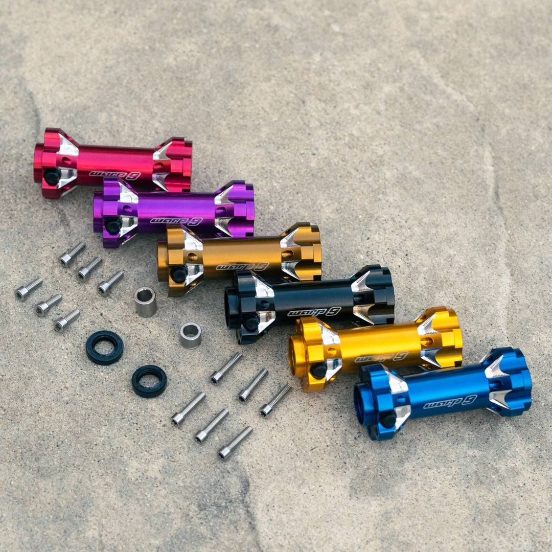 Warp 9 jackshaft kit with color options, including red, purple, black, gold, and blue finishes, with hardware components