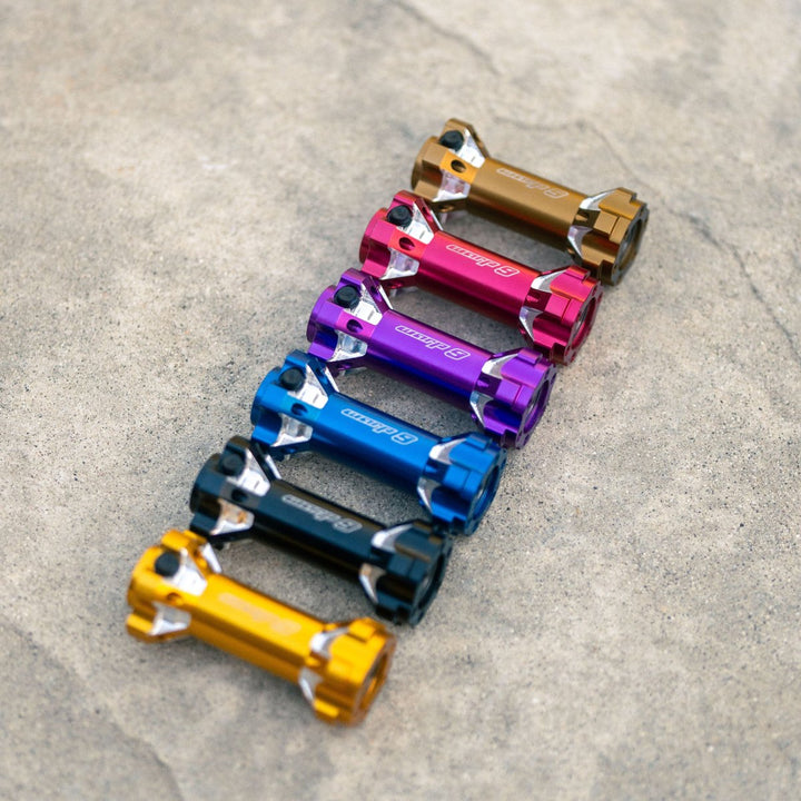 Lineup of Warp 9 jackshafts in multiple colors, including red, purple, blue, black, and gold finishes