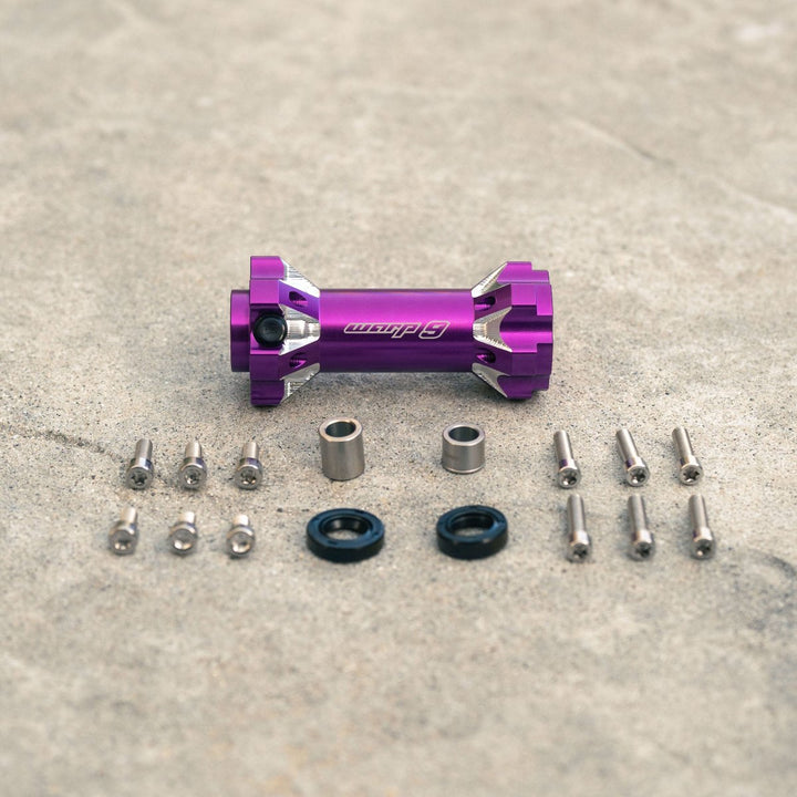 Warp 9 jackshaft kit in purple color with components, including bolts, seals, and distance tubes